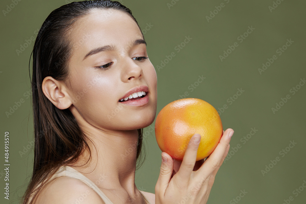 beautiful woman with grapefruit near face clean skin care health close-up Lifestyle beautiful woman with grapefruit near face clean skin care health close-up Lifestyle