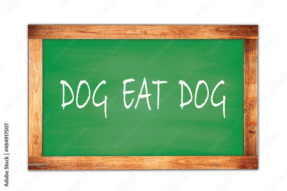 DOG EAT DOG text written on green school board. DOG EAT DOG text written on green school board.
