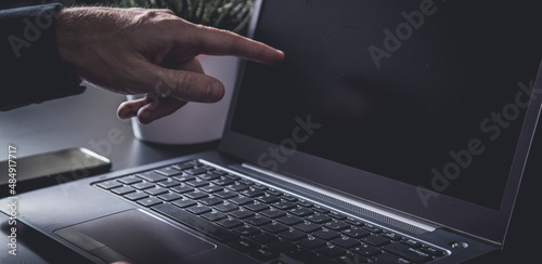 Businessman using a smartphone and notebook in a moddy office photo