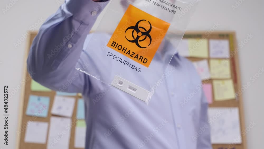 Office Worker showing Biohazard Specimen Bag with Positive PCR Antigen ...