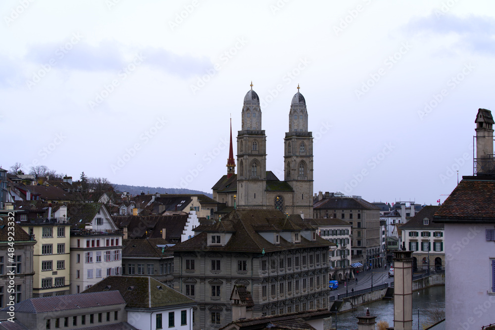 Protestant church Great Minster at the old town of Zürich with gray sky background on a winter day. Photo taken February 1st, 2022, Zurich, Switzerland.