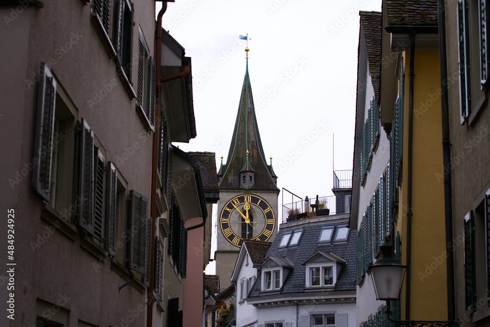 Protestant clock tower of church St. Peter with gray sky background on a winter day. Photo taken February 1st, 2022, Zurich, Switzerland.
