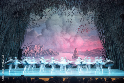 Classical ballet on stage of Theater. Ballet dancers on stage dance classical works. Form of artistic ball dance on stage of theater.