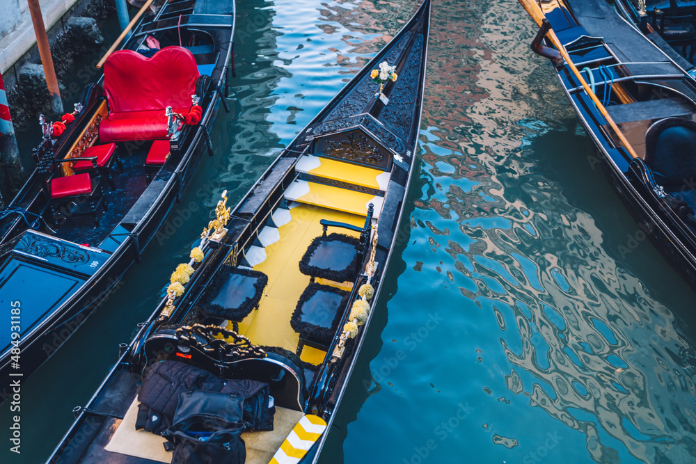 Venezian gondola as taxi transportation for have water sightseeing excursion around cityscape, boat for crossing Grand Canal in Italian lagoon - have romantic trip around famous city Venice