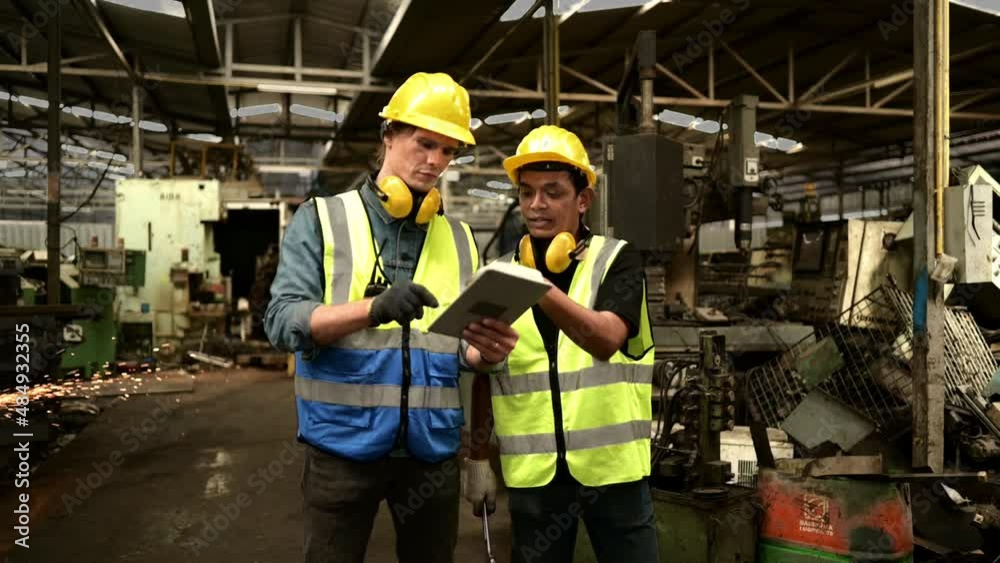 Chief engineer came to inspect the old mechanical factory. There is chief mechanic explaining details and progress reports on old machines being repaired to restore normal operation. Chief engineer came to inspect the old mechanical factory. There is chief mechanic explaining details and progress reports on old machines being repaired to restore normal operation.