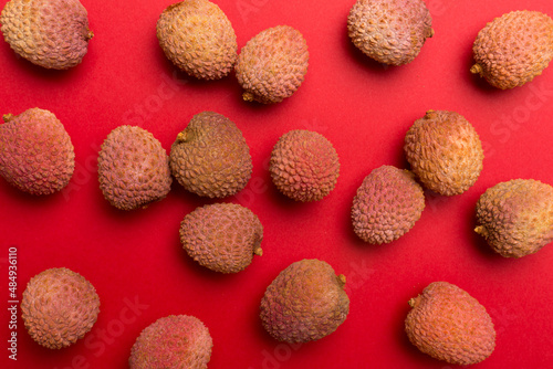 Lychee fruit on color background. Top view, flat lay