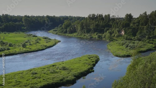 Russia. June 20, 2021. Novgorod region. Picturesque view of the Msta River near the town of Borovichi in sunny weather from the high bank.