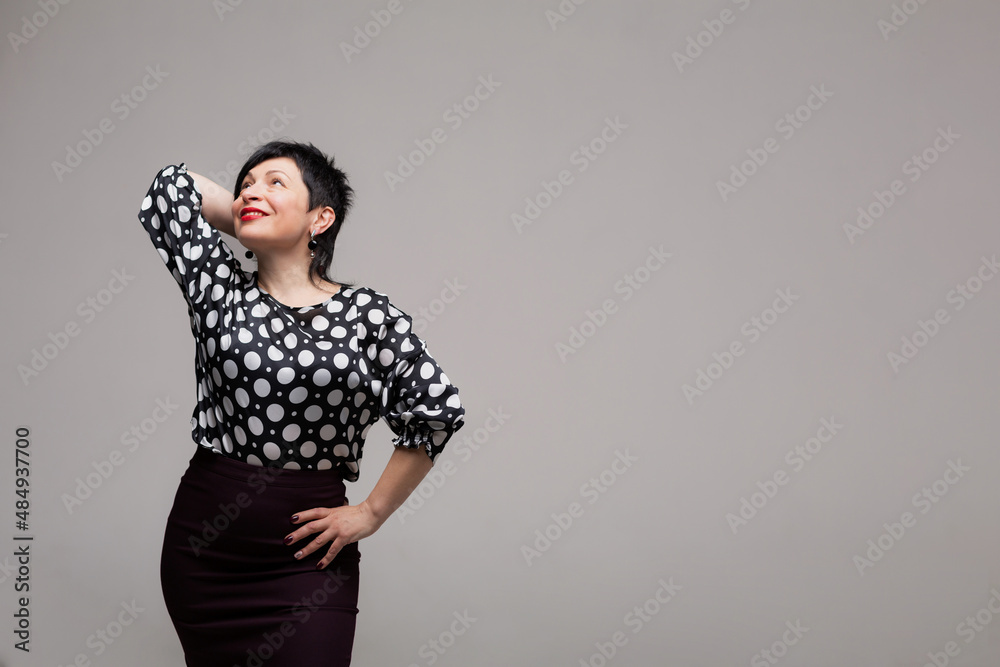 Woman posing in the studio on a white background in office clothes