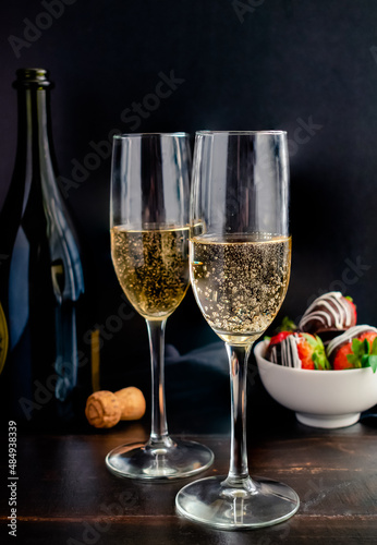 Full Length View of Champagne in Flute Glasses: Bubbly sparkling wine in champagne glasses with chocolate covered strawberries