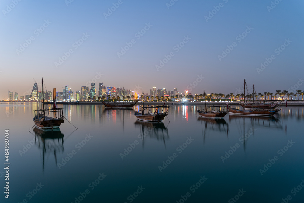 Traditional boats called Dhows are anchored in the port near the Museum of Islamic Art Park Doha, Qatar