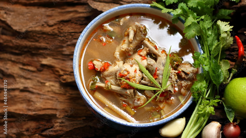 Chicken Feet Spicy Soup with with Marijuana Leaves on wooden background Chicken Feet Spicy Soup with with Marijuana Leaves on wooden background