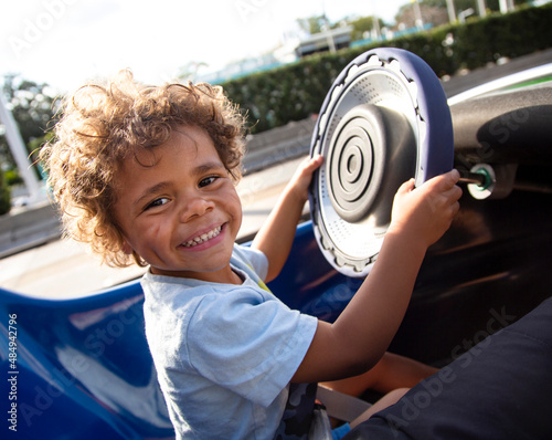Картината върху платно Cute Smiling African American child driving a fun go cart ride at an outdoor amu