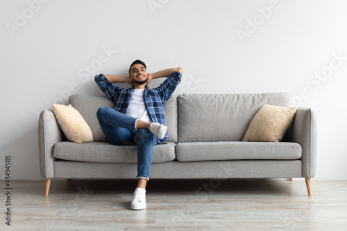 Fototapeta Man having rest at home on the couch