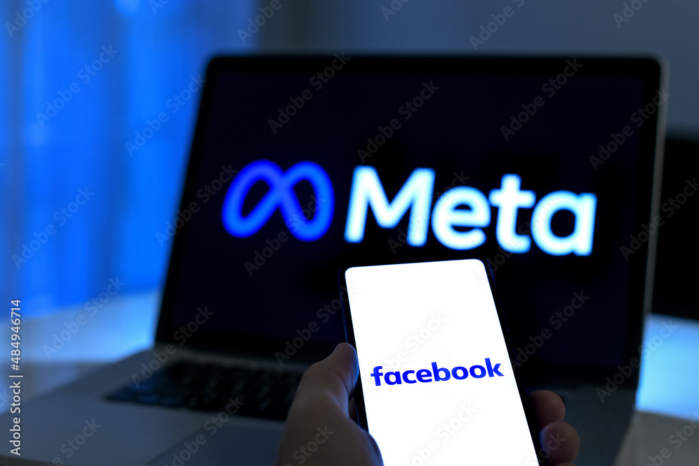 Laptop and smartphone with Meta and Facebook logo on display. New Mark ...