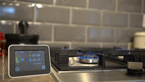 Gas and electricity smart meter recording energy usage against a gas ring burner
