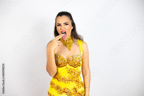Young beautiful woman wearing carnival costume over isolated white background disgusted with her hand inside her mouth