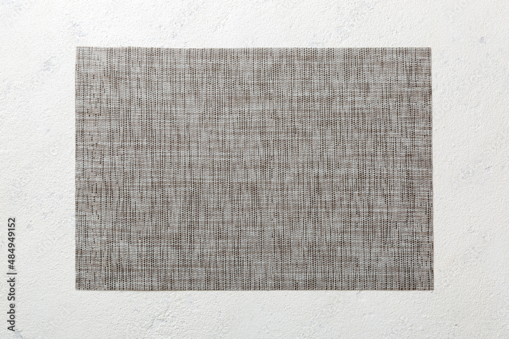 Fototapeta premium Top view of grey tablecloth for food on cement background. Empty space for your design