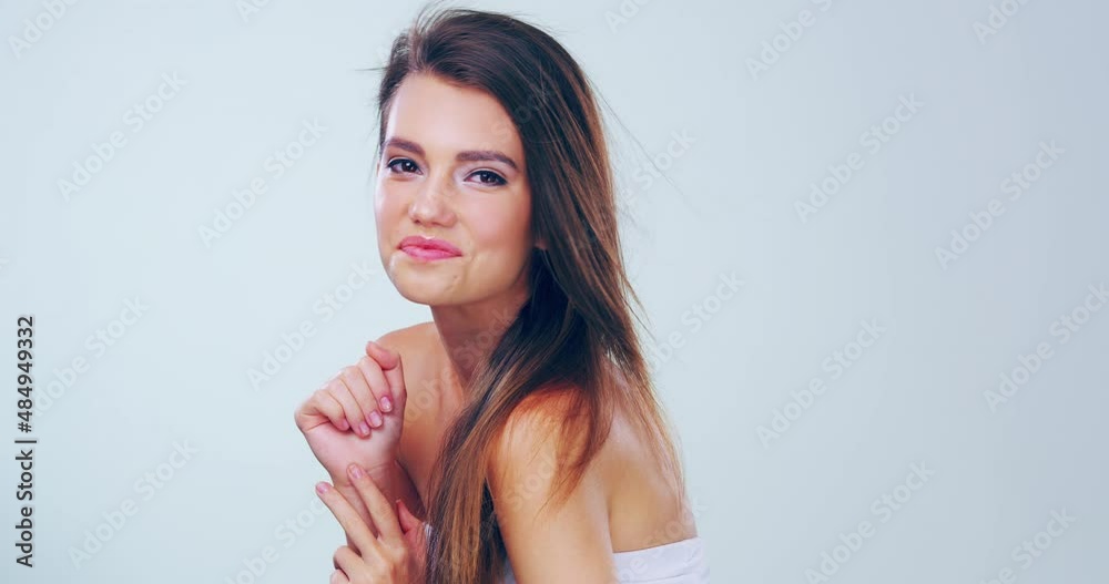Her confidence is charming. Beautiful young woman flicking hair in studio. Confident model posing in studio, flipping hair, beauty, hair care, smooth, hair flip, motion, carefree, hair blowing in wind