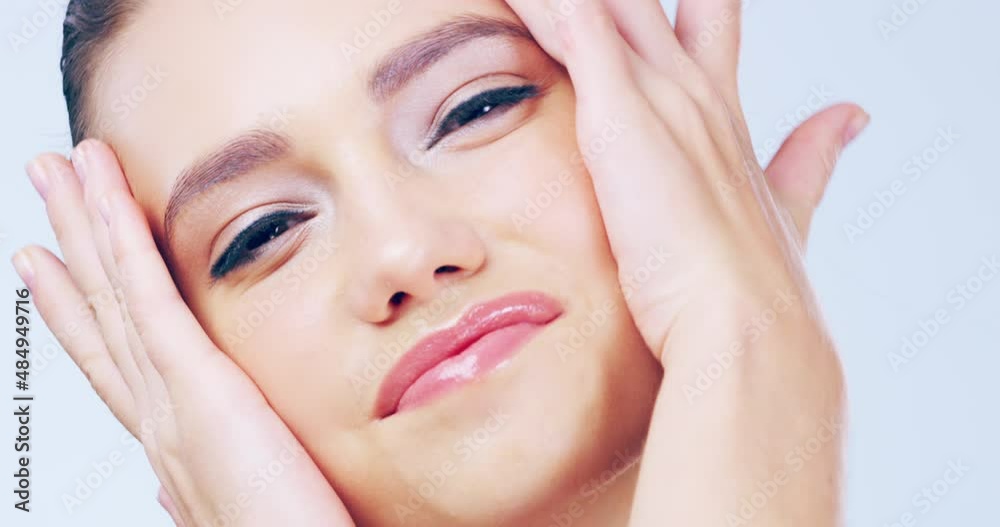 Her beauty regime has given her confidence. Beautiful young woman touching her flawless face skin against a studio background. Head shot portrait of woman touching perfect smooth face skin. Her beauty regime has given her confidence. Beautiful young woman touching her flawless face skin against a studio background. Head shot portrait of woman touching perfect smooth face skin.