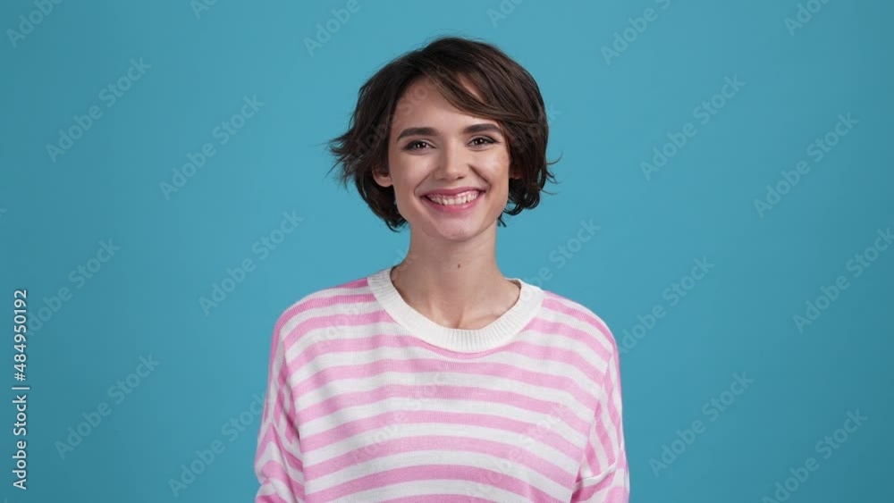 Optimistic lady beaming smiling in camera isolated blue color background Optimistic lady beaming smiling in camera isolated blue color background