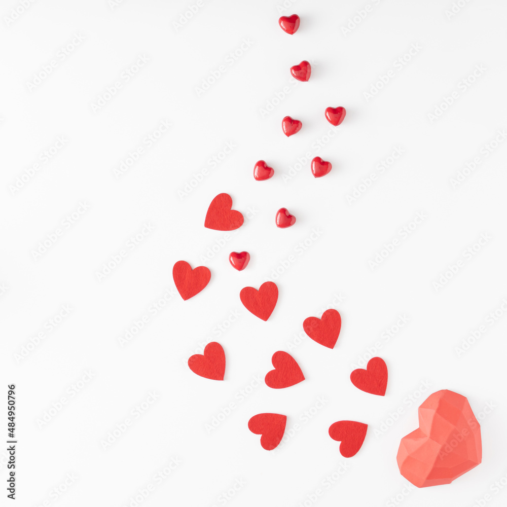 Valentine's Day.love creative composition of different sizes red hearts arranged from largest to smaller on white background. Flat lay. Copy space.