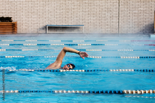 Wallpaper Mural Professional male swimmer swimming in the pool Torontodigital.ca