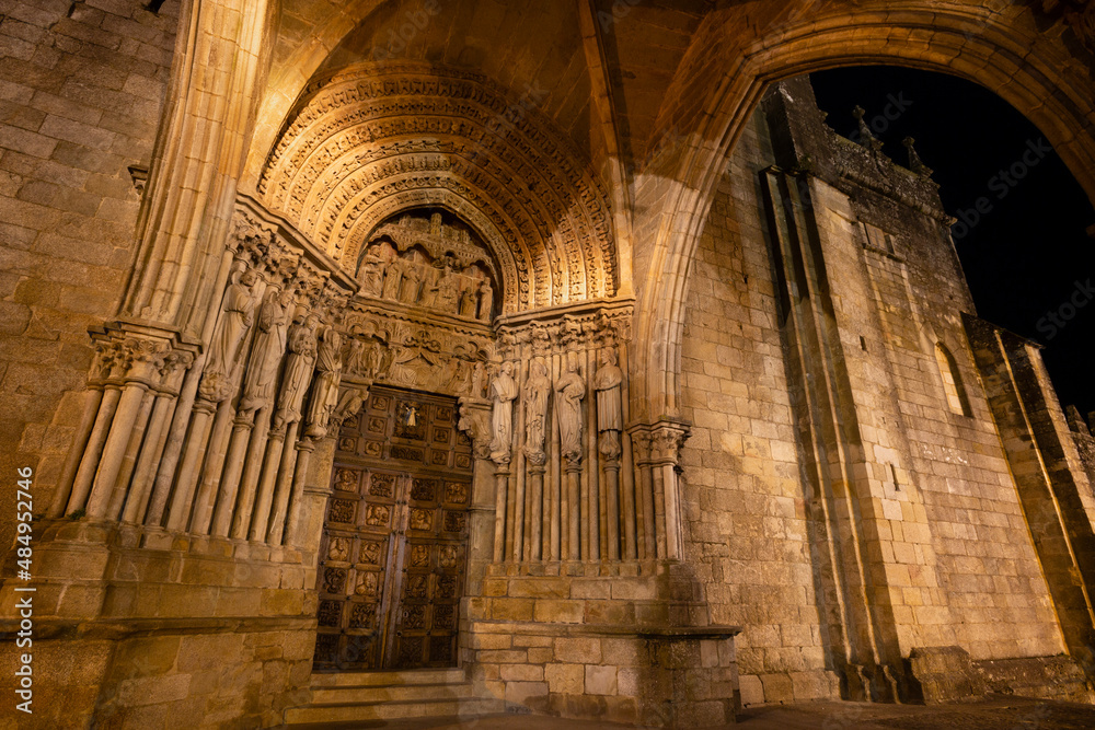 Gothic sculptural ensemble of the main portal of the Cathedral of Tui at night.