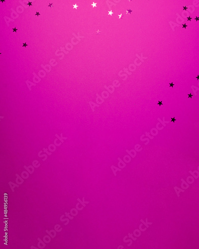 Purple stars shapes at the top on pink background. Christmas winter holiday concept flat lay top view with copy space