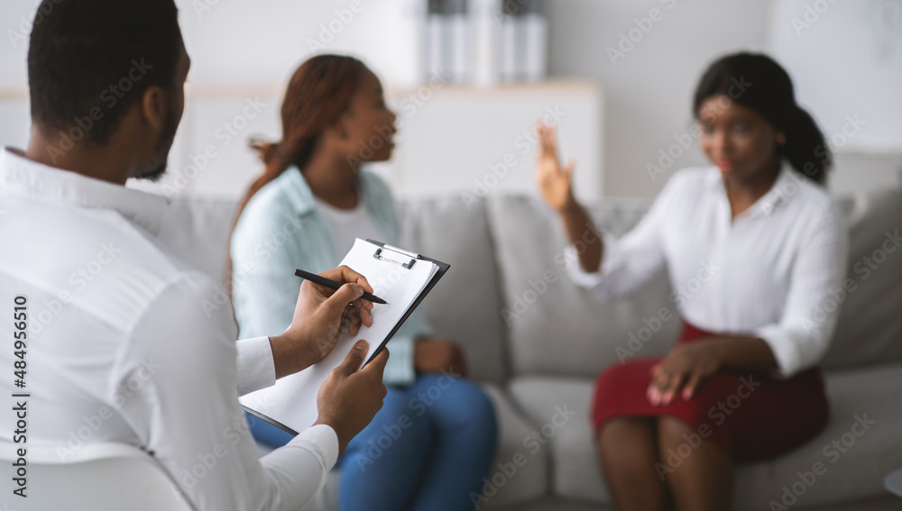 Black homosexual couple having conflict during consultation with marital counselor at office, banner design. Copy space Black homosexual couple having conflict during consultation with marital counselor at office, banner design. Copy space