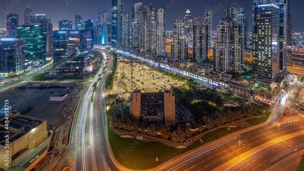 Bay Avenue with modern towers residential development in Business Bay aerial panoramic night timelapse, Dubai