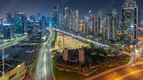 Bay Avenue with modern towers residential development in Business Bay aerial panoramic all night timelapse, Dubai