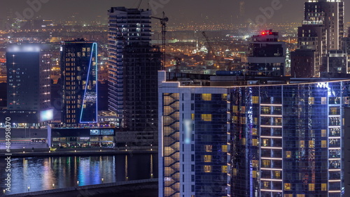 Business Bay Dubai skyscrapers with water canal aerial night timelapse. © neiezhmakov