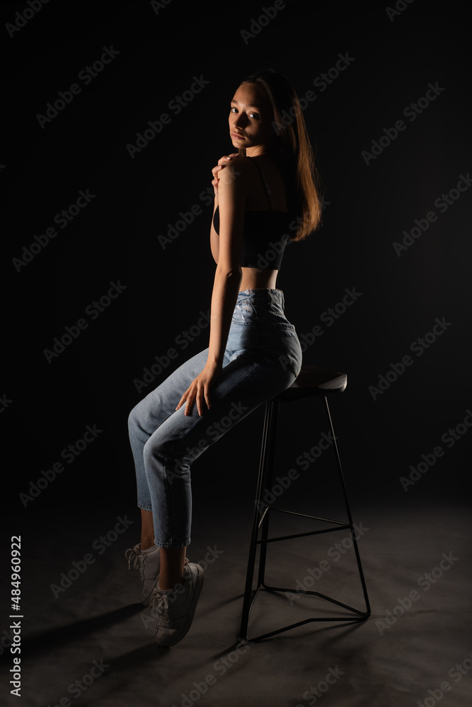 Posing on high chair in studio