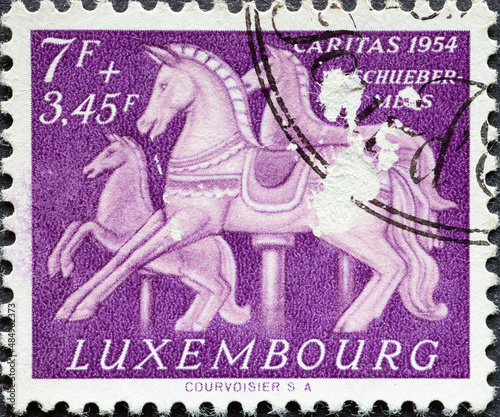 Luxembourg - circa 1954: a postage stamp from Luxembourg, showing Carousel Horses