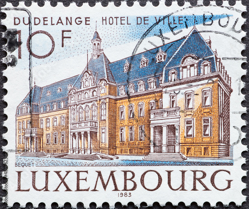 Luxembourg - circa 1983 : a postage stamp from Luxembourg, showing the hotel of the Dudelange site photo