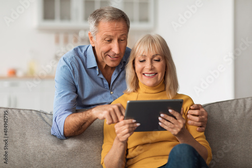 Senior Husband And Wife Using Digital Tablet Together At Home