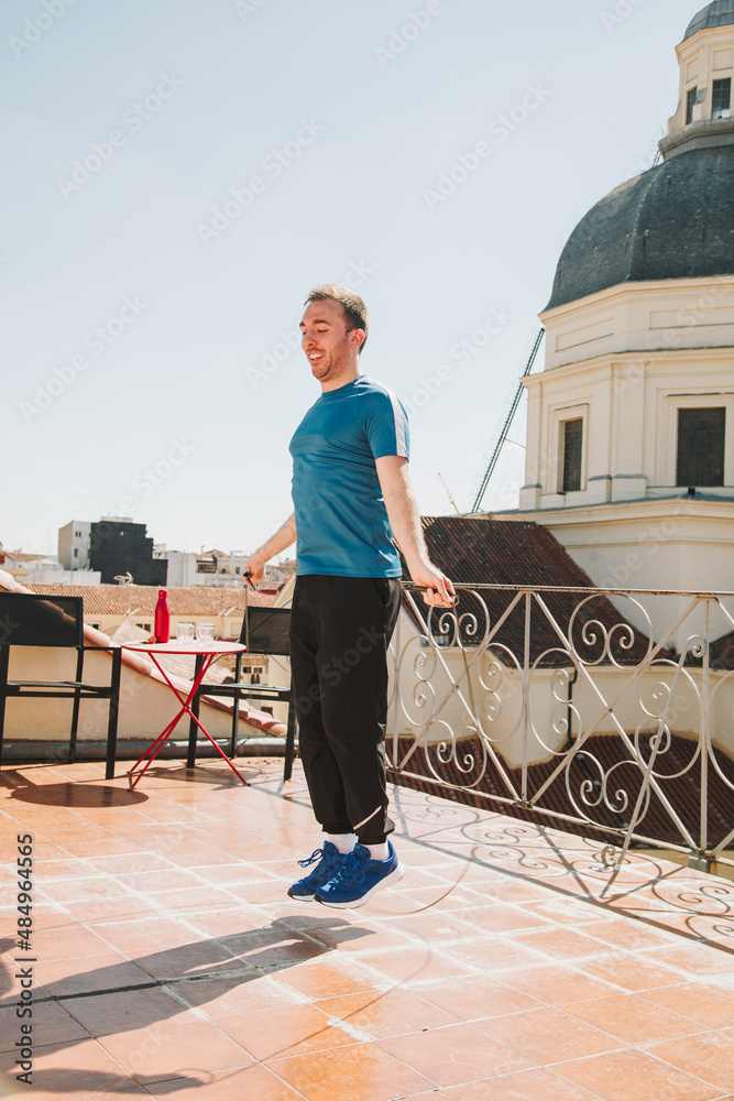 A man exercising on the rooftop using jumping rope during the lockdown