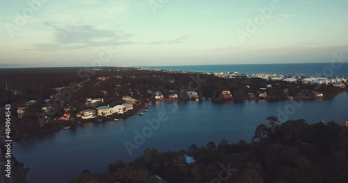 Aerial push in of beautiful homes on small bay at sunset in Florida