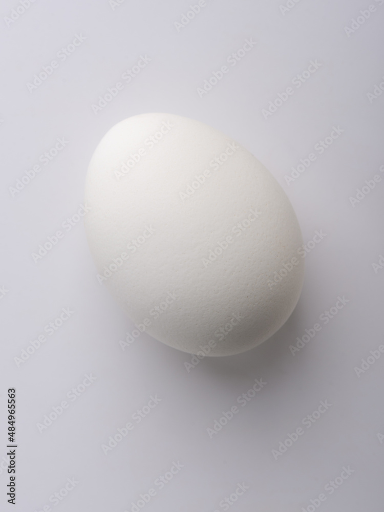 Light and shadow on a chicken egg. Light on the sharp end of the egg. Light and shadow on a chicken egg. Light on the sharp end of the egg.