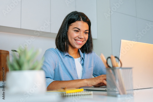 Young business woman working using laptop sitting at the desk