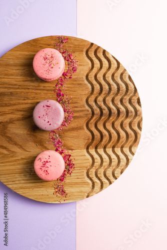 pink macaroons on a wooden background. colored background. High quality photo