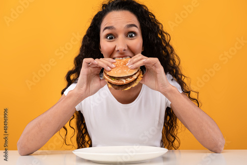 Closeup Of Funny Lady Eating Burger At Studio
