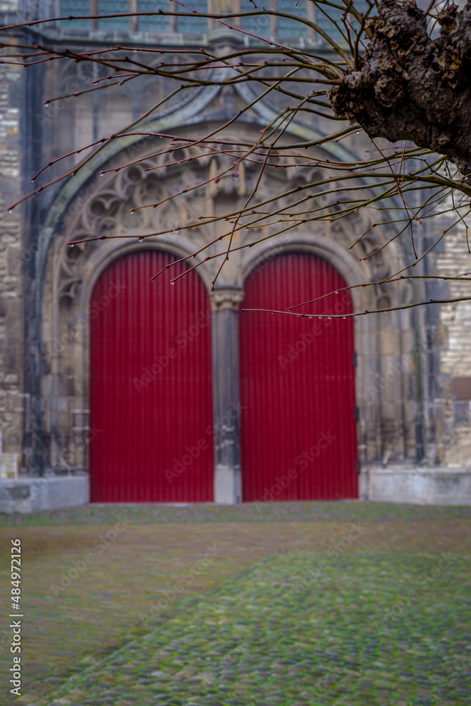 View on the red doors of Hooglandse church in the fog, Leiden, Netherlands