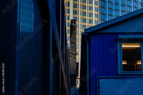 21 December 2021, Rotterdam, Netherlands, Modern and old office building with glass facade on a clear sky background. Transparent glass wall of office building.