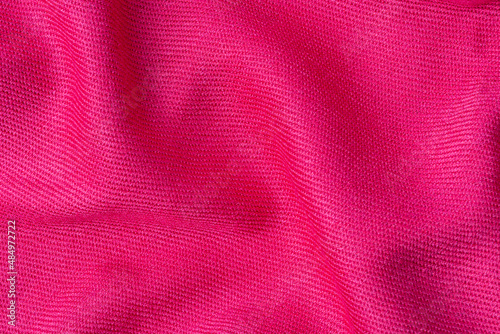 wrinkled pink fabric texture background close up