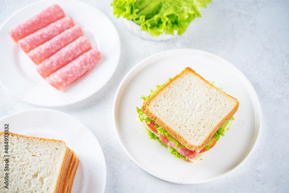 Sandwich with sausage, cheese and tomato for lunch Sandwich with sausage, cheese and tomato for lunch