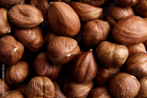 Shelled raw hazelnuts background closeup