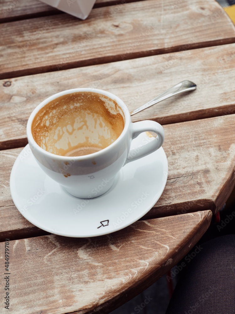 Fototapeta premium Empty coffee cup on a round wooden table 