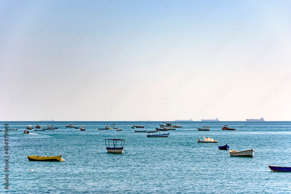 Obraz premium Evening at Todos os Santos bay in Salvador Bahia during a sunny summer day with its moored boats and the skyline
