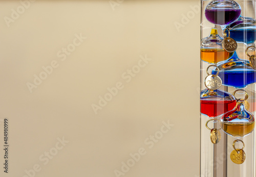 Galileo thermometer with bright colors and reflections in different backgrounds photo